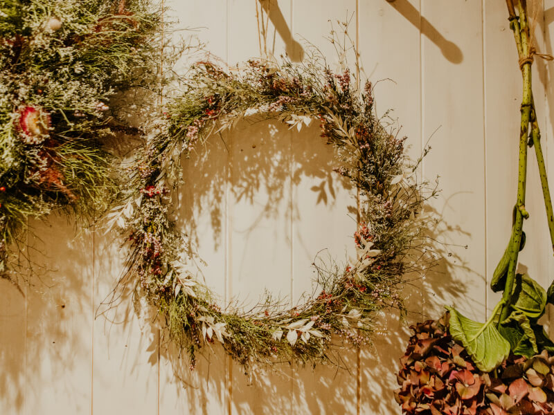 Dried floral wreath hanging on wall